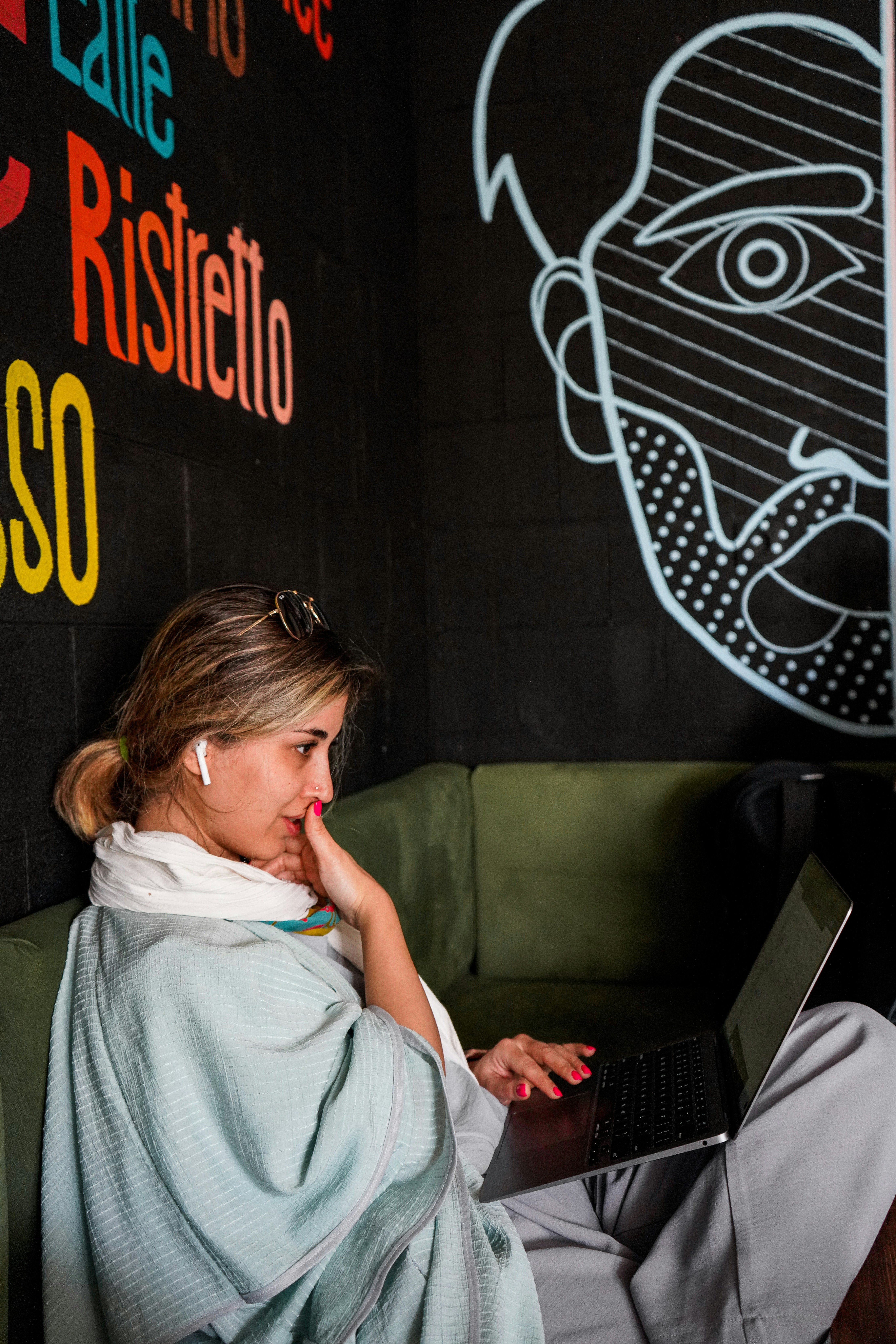 Two business partners discussing a project on a laptop in a modern office.