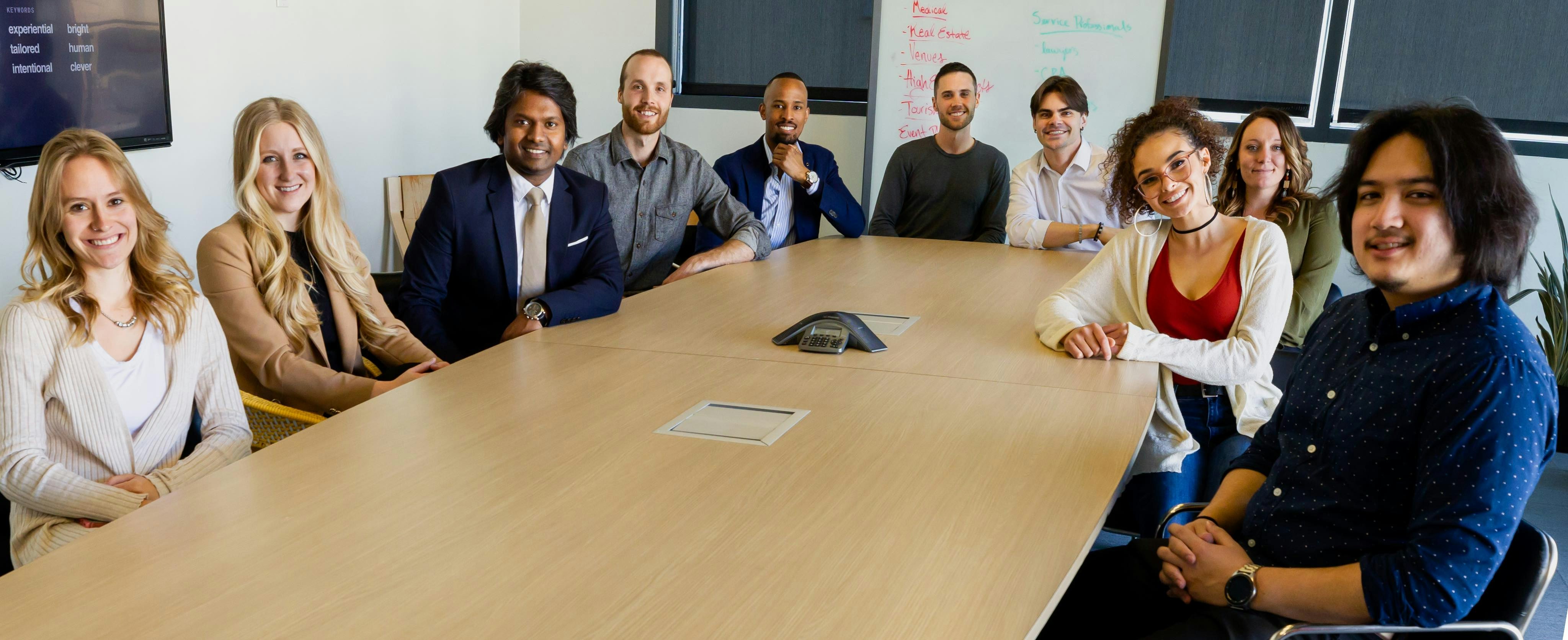 Entrepreneurs brainstorming with sticky notes on a glass wall.