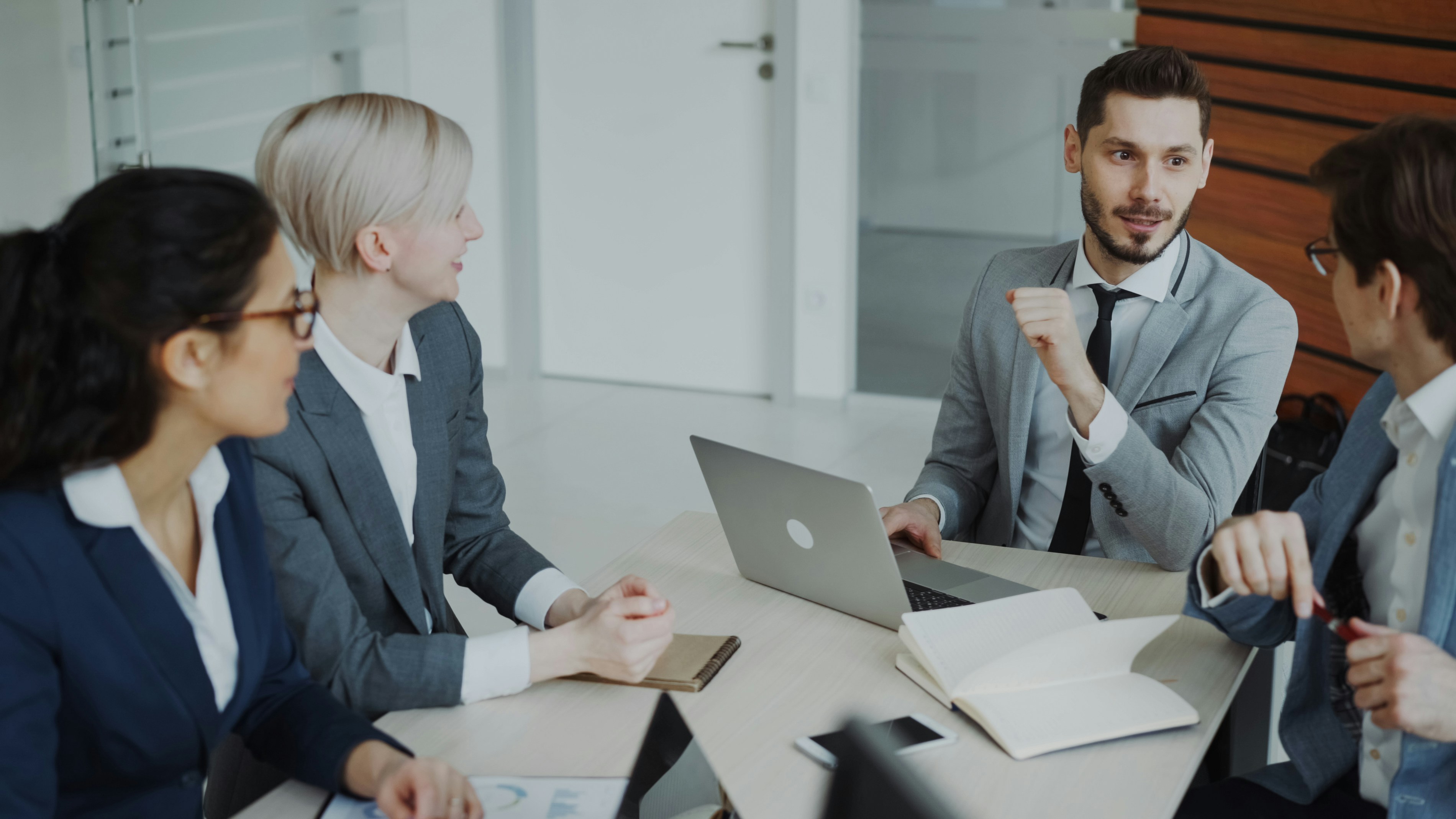 A team of professionals collaborating in a modern startup office environment.