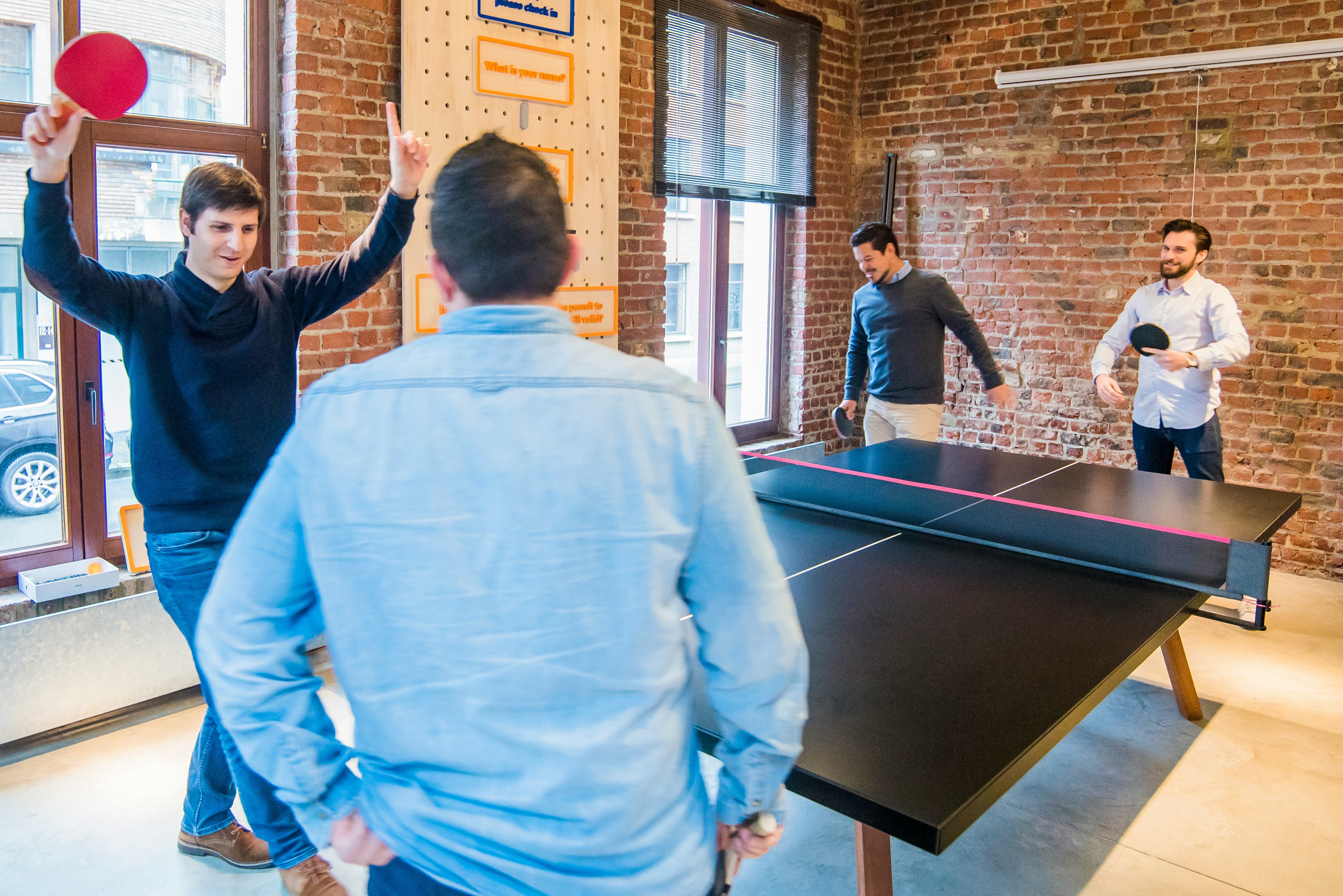 Startup team collaborating in a modern office, discussing strategy on a whiteboard.