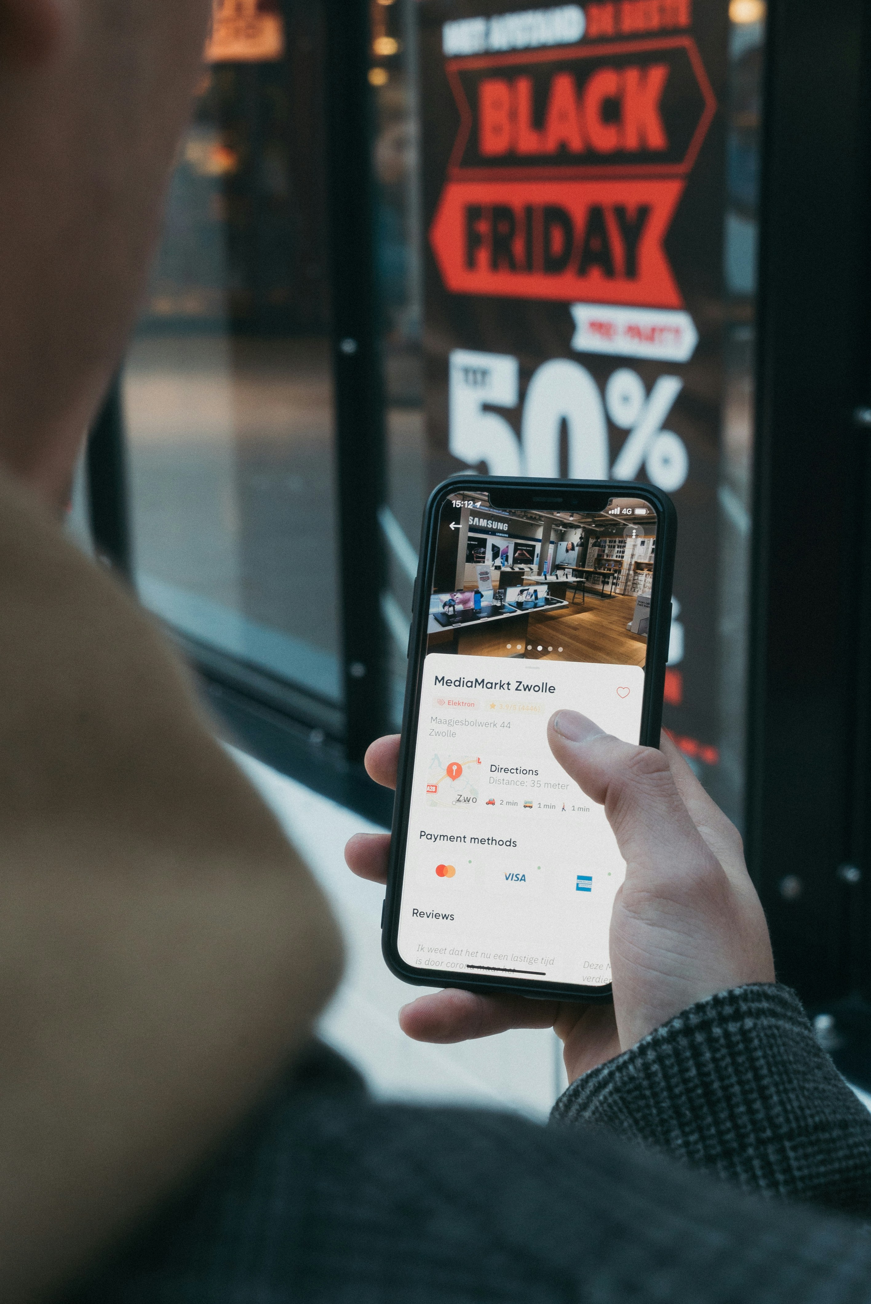 A person scrolling through an online shopping feed on a smartphone.