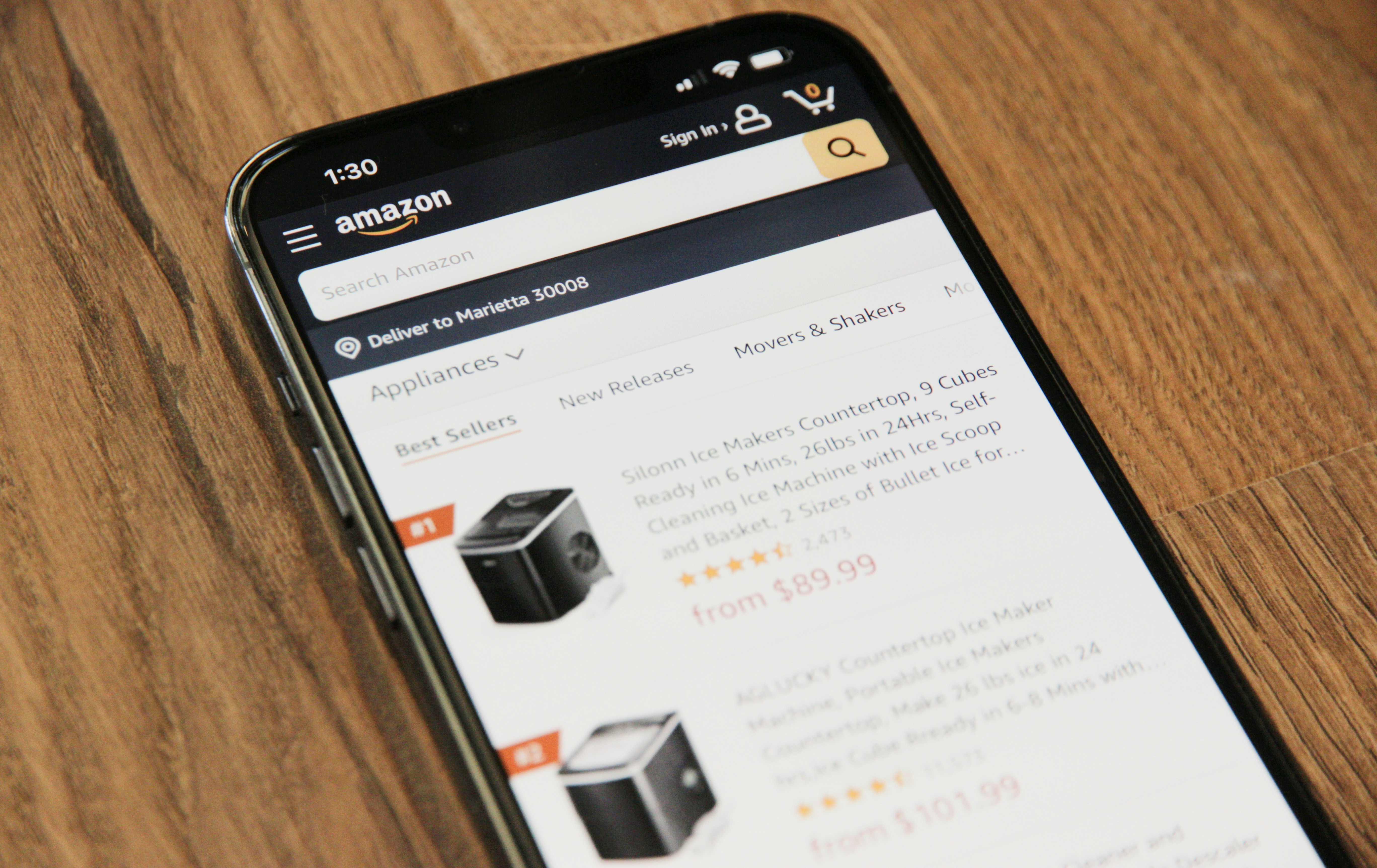 A tablet displaying an e-commerce website interface with various products.